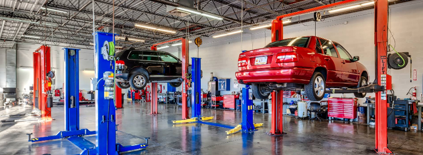 Red Volvo S70 Sedan Lifted on a Mechanical Hoist